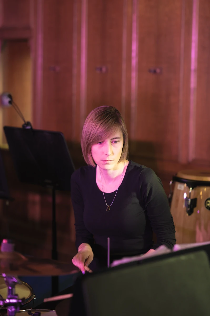 A jazz drummer casually practicing before a performance