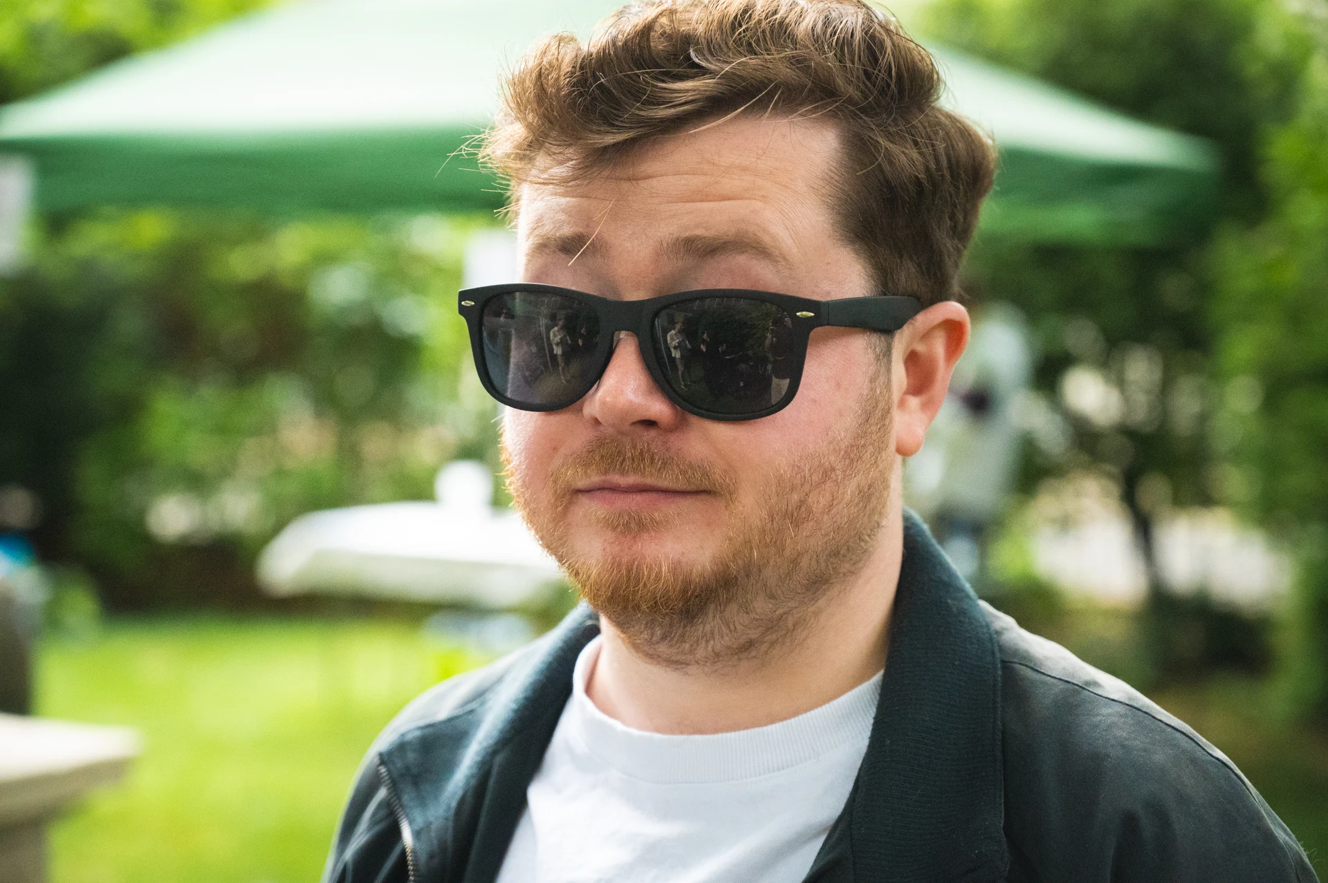 A man with sunglasses on with his eyebrows raised.
